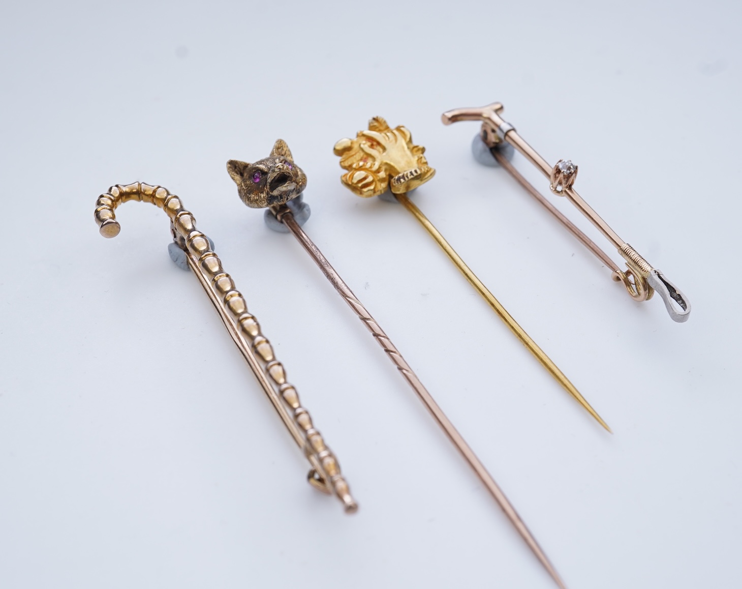 A collection of four tie pins, circa 1900